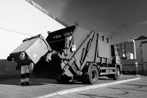Construction site with waste being cleared by professionals